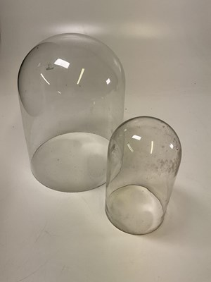 Lot 230 - Two glass domes, taller height 32cm, width...