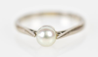 Lot 254 - An 18ct white gold and pearl set ring, size J,...