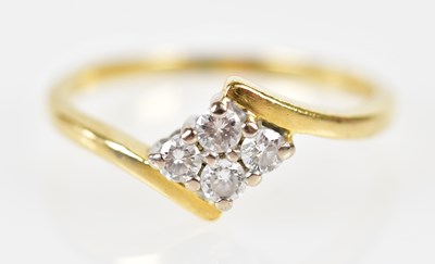 Lot 203 - An 18ct yellow gold four stone diamond ring...