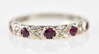 Lot 290 - A 9ct white gold diamond and ruby half...