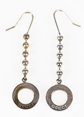 Lot 846 - GUCCI; a pair of silver hoop and bead drop...