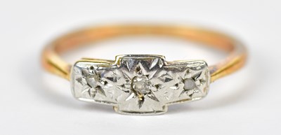 Lot 256 - A yellow metal and tiny diamond three stone...