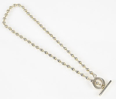 Lot 821 - GUCCI; a silver bead necklace with toggle and...