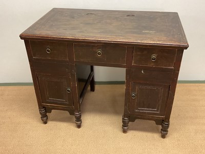 Lot 677 - A knee hole desk, three drawers over two...