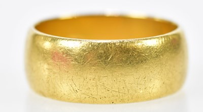 Lot 141 - An 18ct broad yellow gold wedding band, size T,...