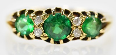 Lot 86 - An 18ct yellow gold emerald and diamond ring...