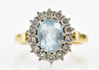 Lot 69 - A yellow metal aquamarine and diamond oval...