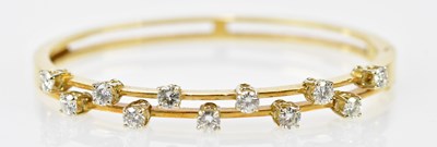 Lot 496 - An 18ct yellow gold diamond set hinged snap...