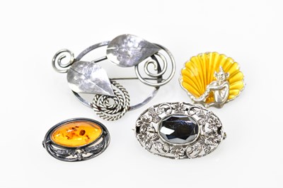 Lot 602 - Four Arts & Crafts inspired brooches including...