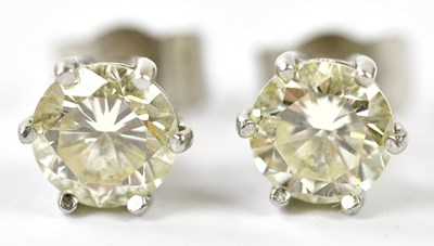 Lot 627 - A pair of white metal diamond ear studs, each...