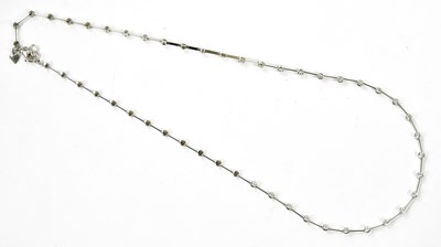 Lot 322 - A white metal diamond set necklace with twenty-...