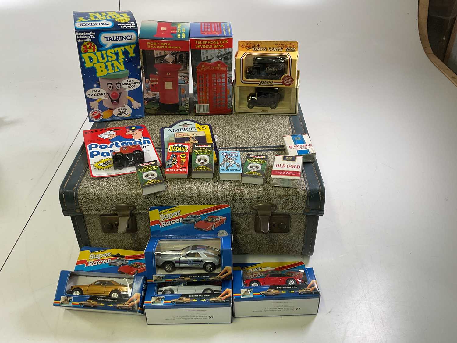 Lot 44 - A suitcase containing a Dusty Bin money box
