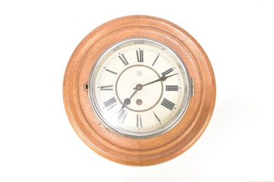 Lot 208 - JUNGHANS; an oak cased circular wall clock,...