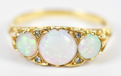 Lot 139 - A yellow metal opal and diamond ring set with...