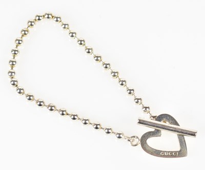 Lot 837 - GUCCI; a hallmarked silver Boule heart...