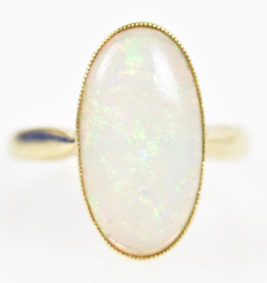 Lot 210 - A 14ct yellow gold and oval opal cabochon ring,...