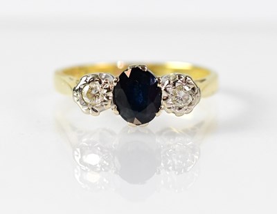 Lot 1044 - An 18ct gold ring set with a central oval...