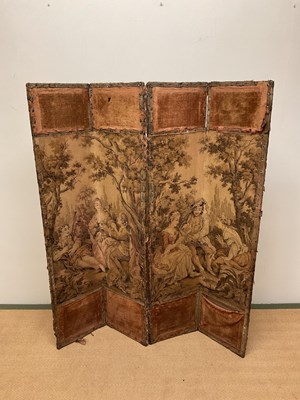 Lot 621 - A four panel folding screen with tapestry...