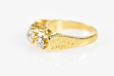 Lot 39 - An 18ct yellow gold three stone diamond ring...