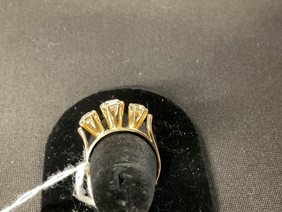 Lot 39 - An 18ct yellow gold three stone diamond ring...