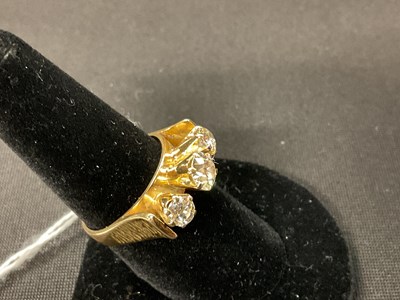 Lot 39 - An 18ct yellow gold three stone diamond ring...