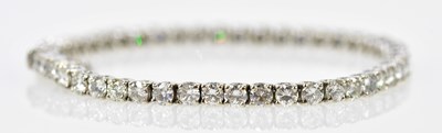 Lot 773 - An 18ct white gold diamond tennis bracelet set...