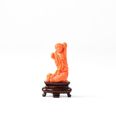 Lot 666 - A small Chinese coral carving of a figure upon...