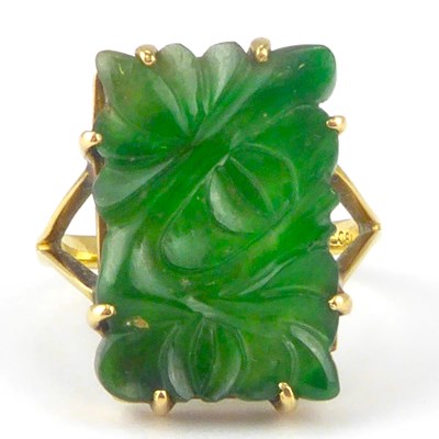 Lot 1045 - An 18ct gold ring with claw set carved floral...