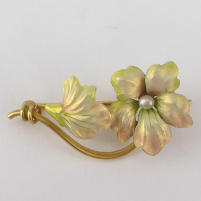 Lot 1084 - A gold and enamelled floral brooch of...