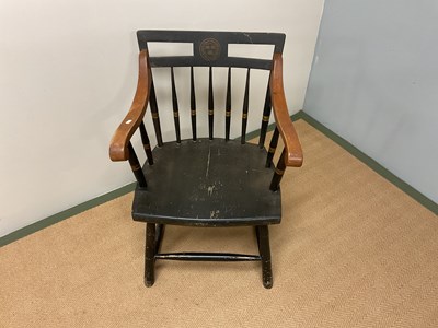 Lot 650 - An American ebonised elbow chair with Harvard...