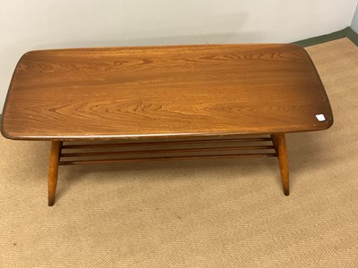 Lot 651 - ERCOL; a coffee table with slatted magazine...