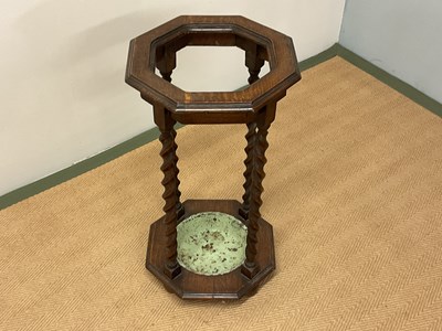 Lot 653 - An octagonal topped oak umbrella stand with...