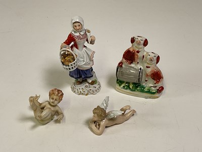 Lot 227 - A Meissen figure of a woman carrying a basket...