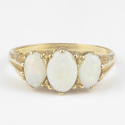 Lot 1012 - A 9ct gold opal ring, the three graduated claw...