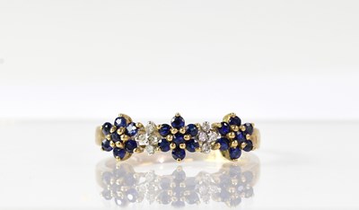 Lot 1025 - A 9ct yellow gold ring set with sapphire and...