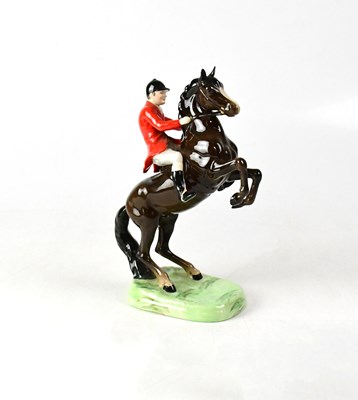 Lot 548 - BESWICK; a huntsman on a rearing brown horse...