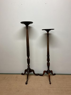 Lot 604 - Two mahogany torcheres, the larger 140cm, the...