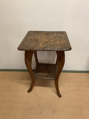 Lot 640 - An occasional table with carved sunflower...