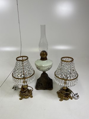 Lot 523 - An oil lamp with cast metal base, with a...