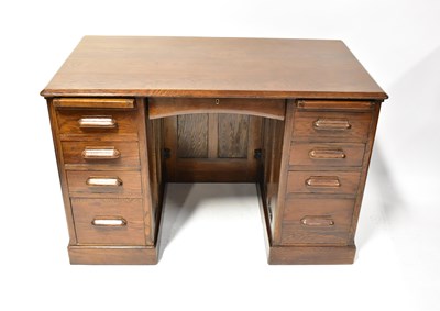 Lot 50 - A vintage oak kneehole desk with central thin...