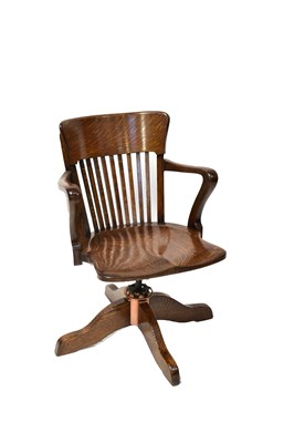 Lot 51 - A vintage oak office chair with slatted back...