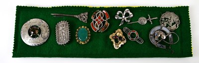 Lot 622 - A group of brooches mounted on a felt pad,...