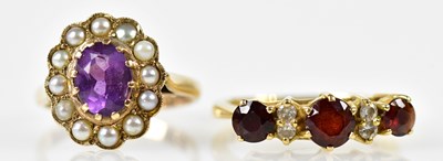 Lot 214 - An 18ct yellow gold diamond and garnet ring,...