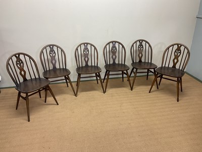 Lot 659 - ERCOL; a set of six dining chairs with fleur...