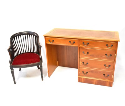 Lot 23 - A modern light wood desk with two drawers over...