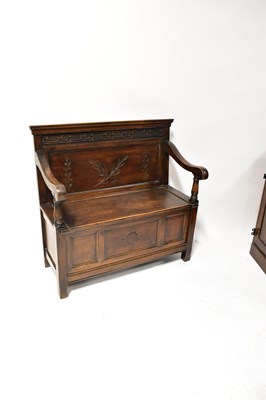 Lot 25 - A reproduction small settle with carved...