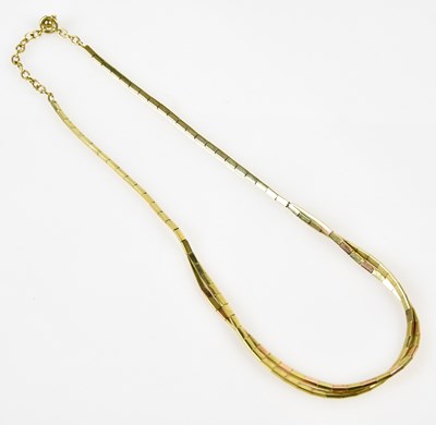 Lot 372 - A yellow metal twin strand necklace stamped...