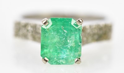 Lot 73 - A white metal emerald and diamond ring, the...