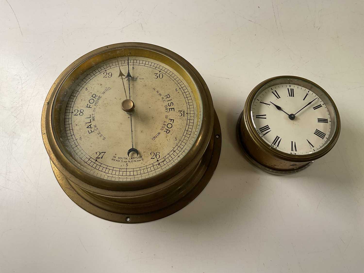 Lot 26 - A Sestral barometer, face diameter 18cm, and a...
