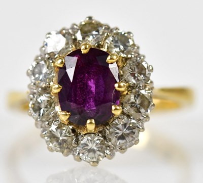 Lot 90 - An 18ct yellow gold ruby and diamond oval...